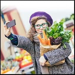 millennial grocery shopper taking a selfie with cellphone