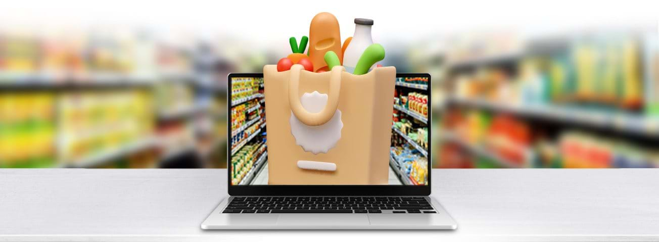 Photo illustration of a computer with a bag of groceries on the screen and a grocery store aisle in the background.