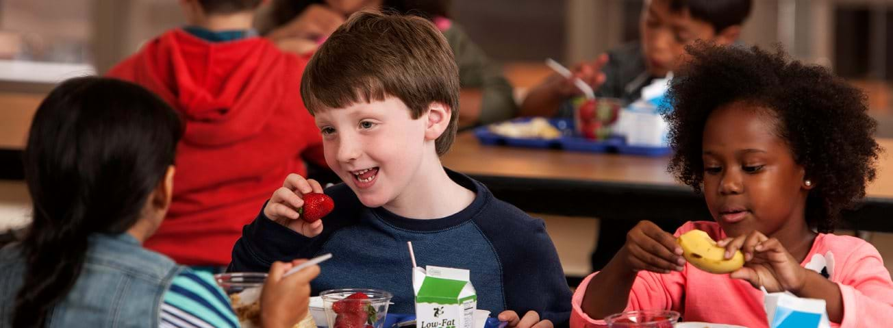 Photo of children eating in a school cafeteria.